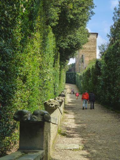 A vertical shot of people walking in the park in Florence, Italy