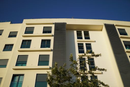 A low angle shot of a high rise city building against a clear blue sky in Lisbon, Portugal