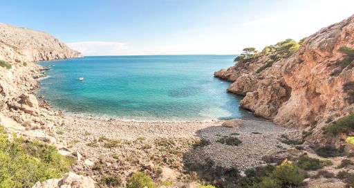 A beautiful view of a sunny seaside with cliffs in Albir, Spain