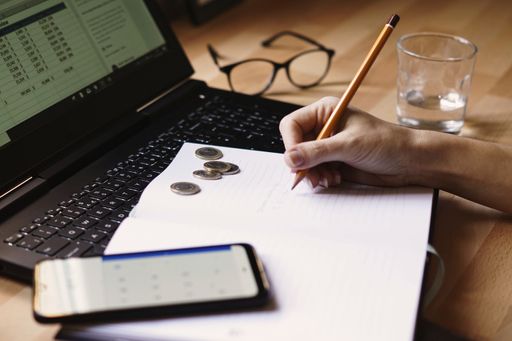 A closeup shot of an entrepreneur working from home on his personal finances and savings
