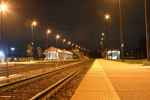 The railroads surrounded by lamps and buildings during the nights