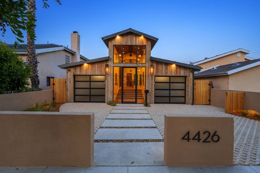 The exterior design of a modern house exterior with warm lighting