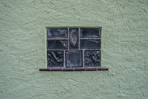 An old glass texture on grunge green wall background