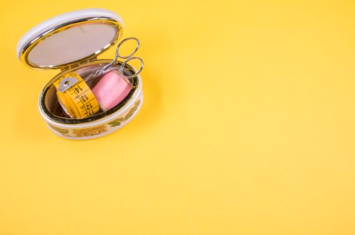 A set of sewing tools isolated on a yellow background with free space for text