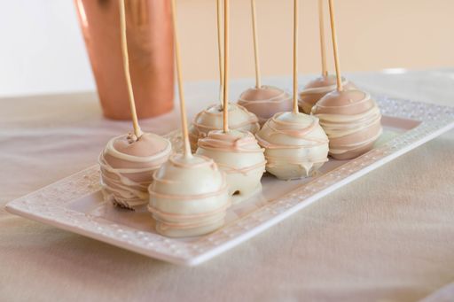 A closeup shot of cakepops with nice design on a white plate