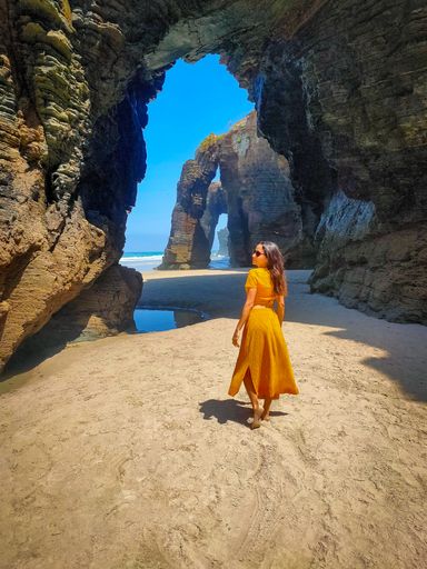A vertical shot of a Hispanic woman posing for a picture during vacation
