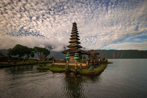 A mesmerizing view of Ulun Danu Beratan Temple under a cloudy sky in Bali, 
Indonesia