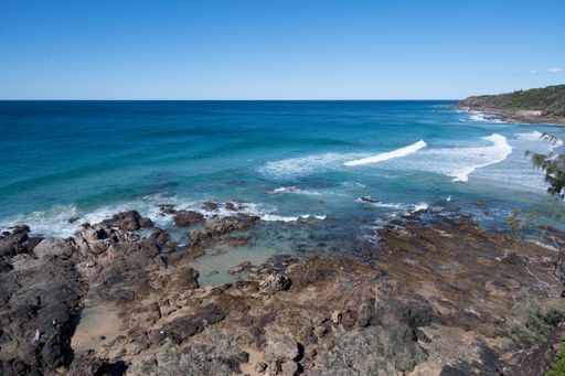 A beautiful view of the Sunshine Coast in Queensland, Australia with a calm blue sea under a clear sky