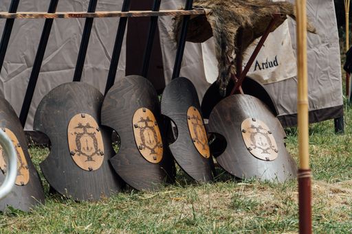 A closeup shot of round metal shields arranged outside on the ground