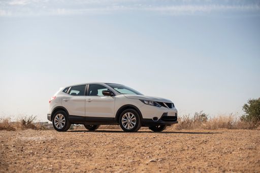 An automobile on the rural field with a clear sky background