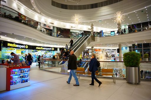 The people walking along shops in the shopping mall of Poznan in Poland