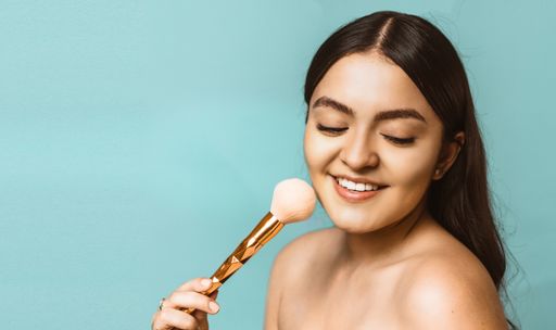 A portrait of a young attractive Caucasian female holding a brush