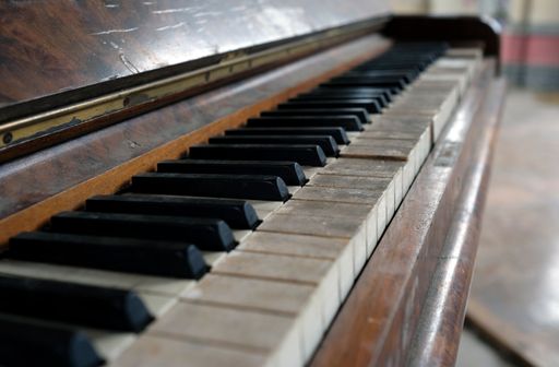 A closeup shot of an old dirty broken piano keyboards
