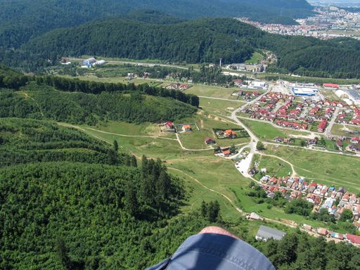 An aerial view of the forested areas and buildings captured from an airplane