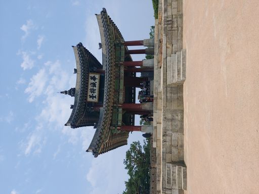A vertical shot the Suwon Hwaseong Fortress under a blue sky in South Korea