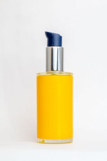 A sleek yellow bottle with a silver and blue pump, isolated on a white background, perfect for cosmetic product advertising.