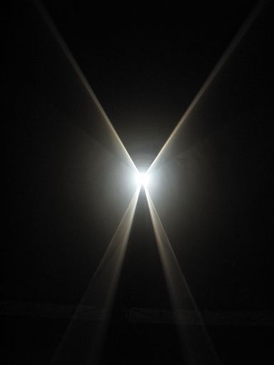 A vertical shot of rays of light wiht a black background