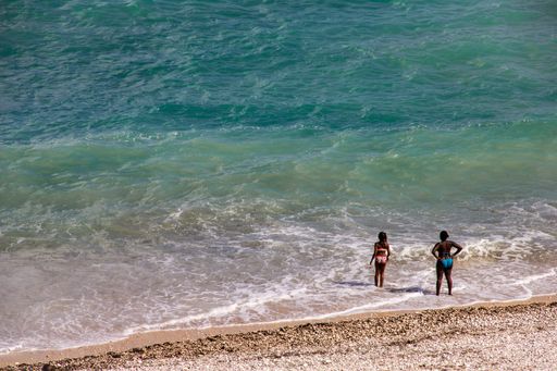 An aerial shot of two female tourist at the beach during a sunny summer daym in Altea, Spain