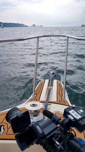 A vertical shot of a camera on the deck of a boat in Tagus river in Lisbon, Portugal