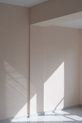 A vertical shot of a sunlight shadow coming from the window