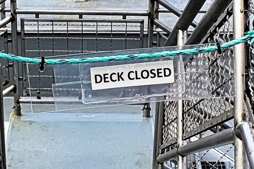 A deck-closed sign with a boundary rope