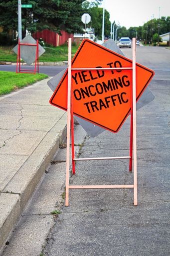 A Yield to oncoming traffic construction signs on the road