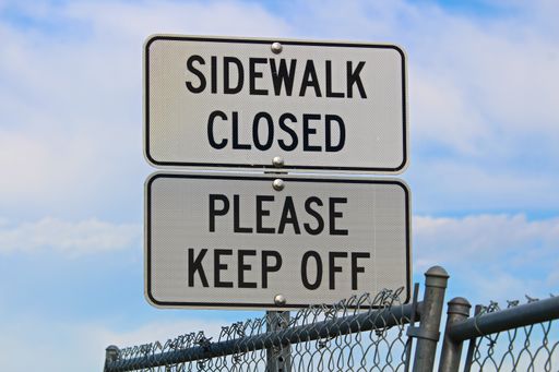 A Sidewalk closed and Please keep off signs