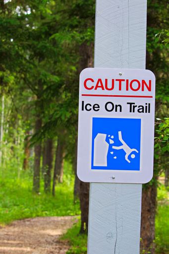 A caution, ice on trail sign in the park