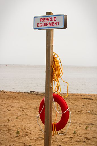 A vertical shot of a rescue equipment station at a public beach