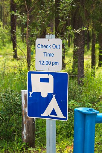 The camping check-out time 12:00 pm message sign