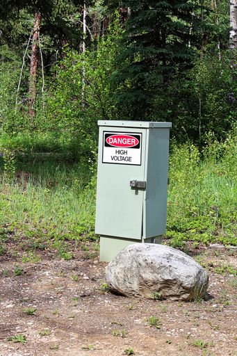 A vertical shot of 'danger high voltage' sign on an electrical box