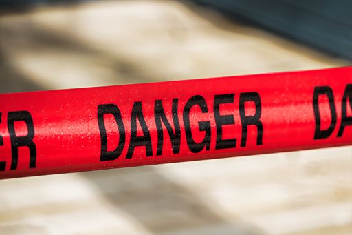 A closeup shot of a red danger tape on a blurred background