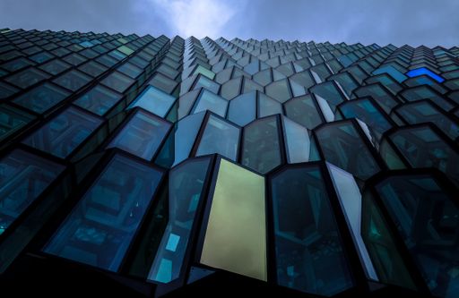 A low angle shot of a blue high rise brutalist architectural building