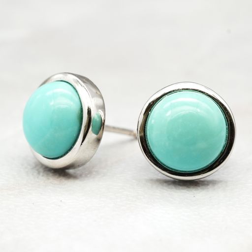 A closeup shot of earrings made of Amazonite gemstone