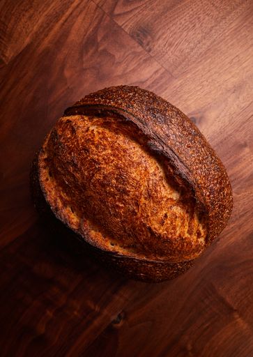 An overhead shot of freshly baked bread on a wooden background