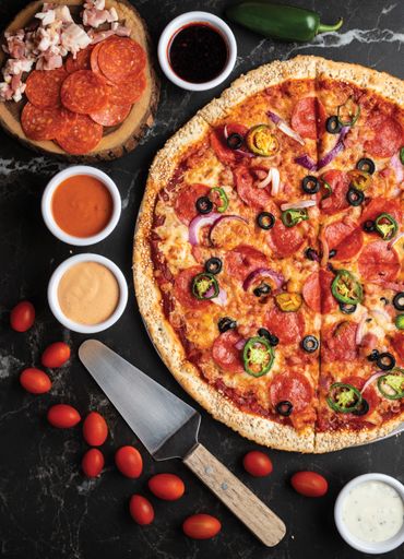 An overhead shot of an appetizing pizza with ingredients