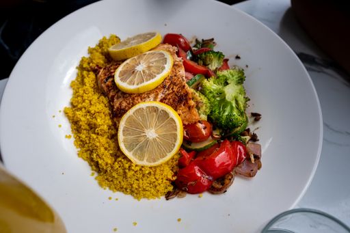 A high angle shot of a plate of traditional food with chicken and vegetables