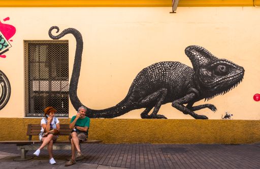 The Couple on bench in the streets of Malaga Soho art district. Malaga Andalusia, Spain.