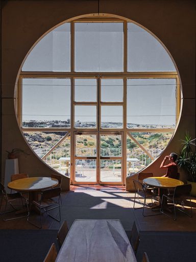 A perfect vertical shot  of a round arch with windows overlooking outside