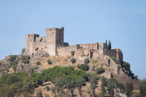 Close-up of the medieval castle of Alburquerque or Luna castle built in the 13th century on a summer day with blue sky.