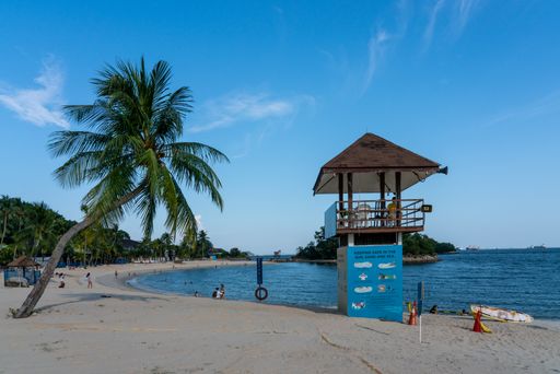 People at Siloso Beach during afternoon, Sentosa Island. Lifeguard tower. Horizontal shot