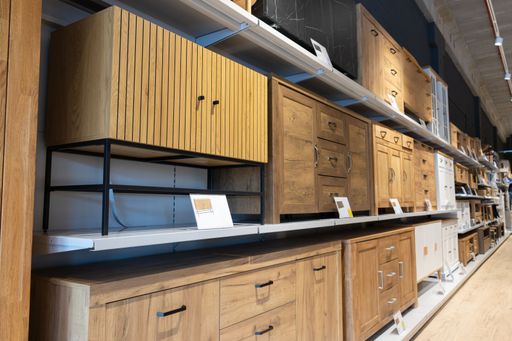 The modern furniture displaying wooden cabinets and shelves in retail store