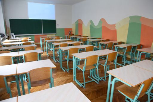 The interior of a classroom with empty chair