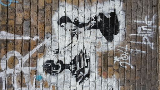 A vertical shot of a black and white street art painting isolated on a brick wall in London