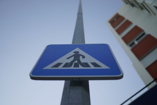 A low angle shot of a pedestrian crossing sign