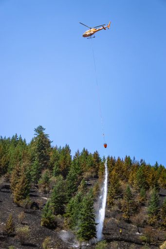 A firefighting plane over beautiful Coldstream Town in Scotland, fighting the Clerke road wildfire