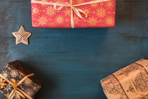 The Christmas gift boxes on a blue surface viewed from above