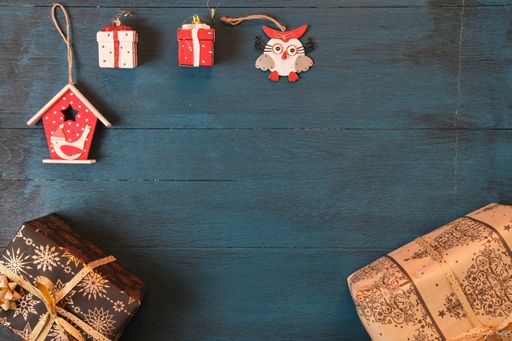 The Christmas tree decoration toys on a blue surface viewed from above