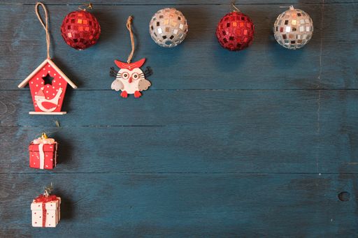 The Christmas tree decoration toys on a blue surface viewed from above