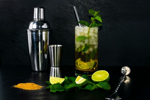 A closeup shot of fresh ingredients for making a Mojito cocktail isolated on a dark background